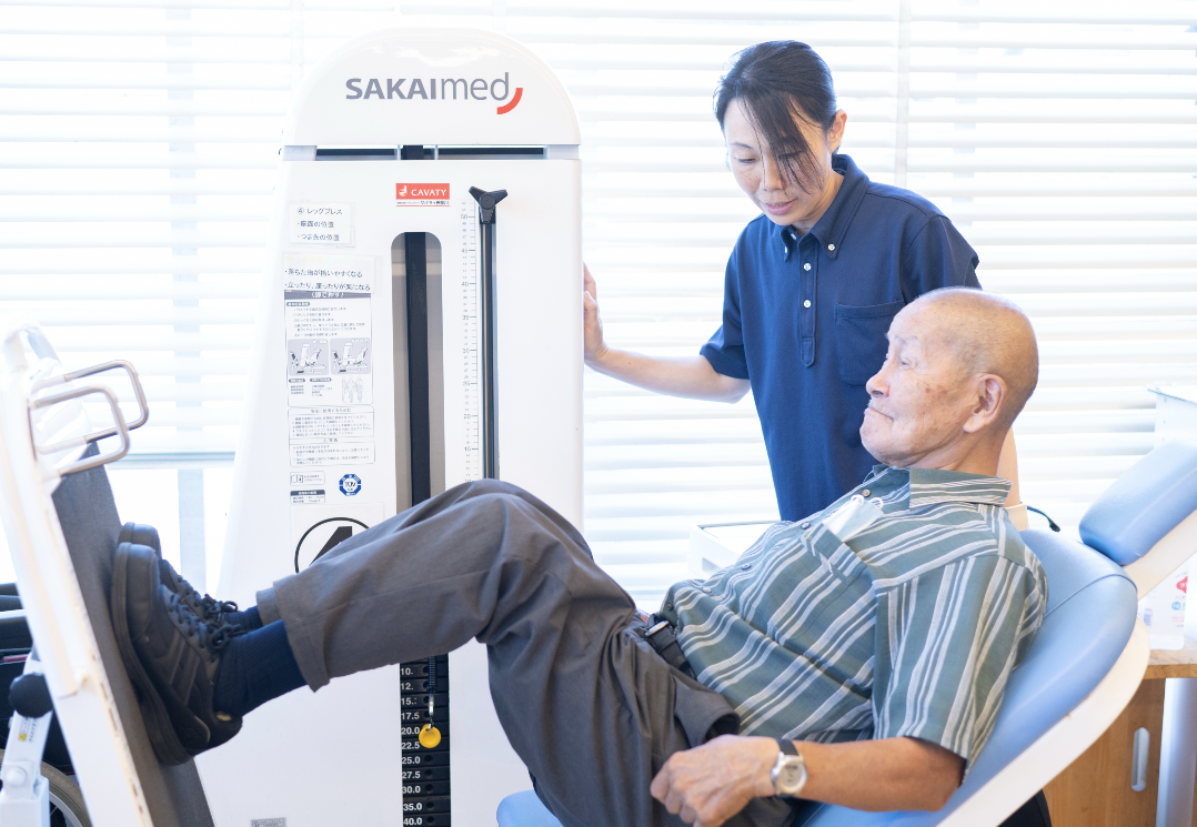 高齢の男性がリハビリマシンで運動している様子